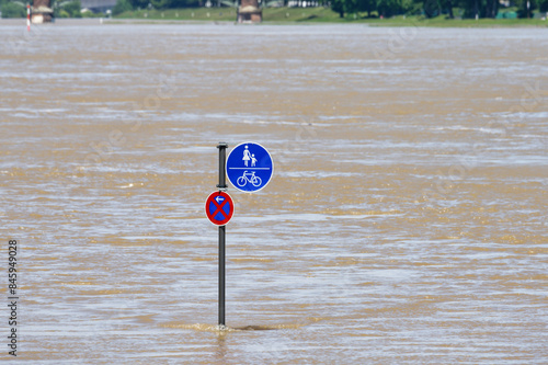 a traffic sign no stopping and pedestrian and cycle path in the middle of the flooding rhine in cologne photo