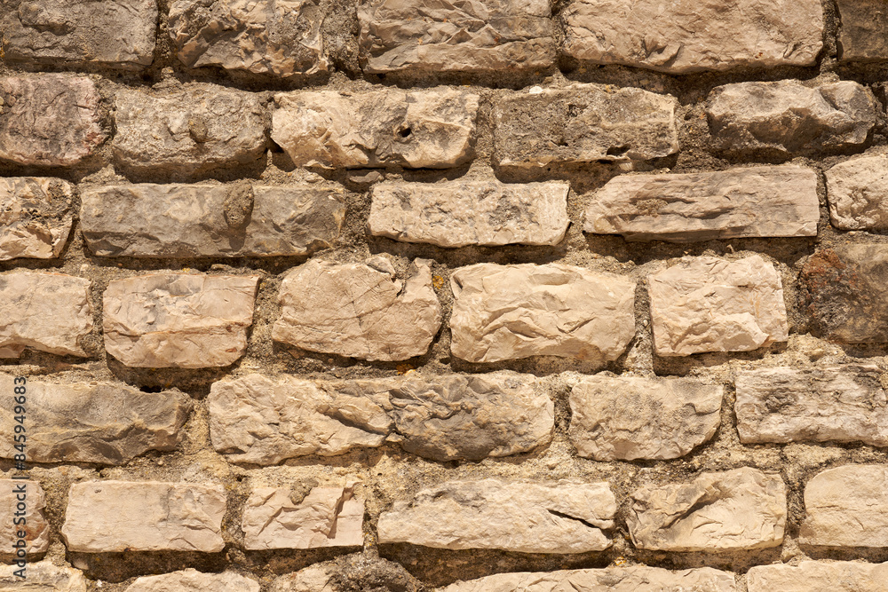 Fototapeta premium A wall of stones on mortar as a background.