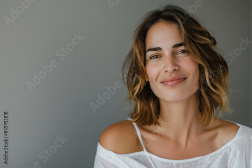 A close up portrait of a woman with a subtle smile