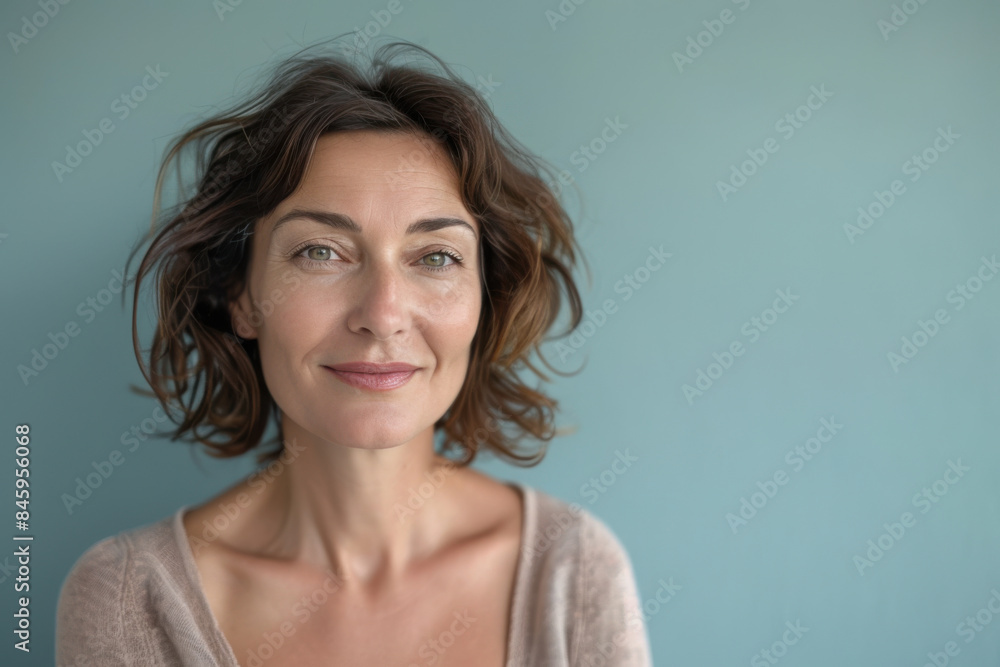 A close up portrait of a woman with a subtle smile A close up portrait of a woman with a subtle smile