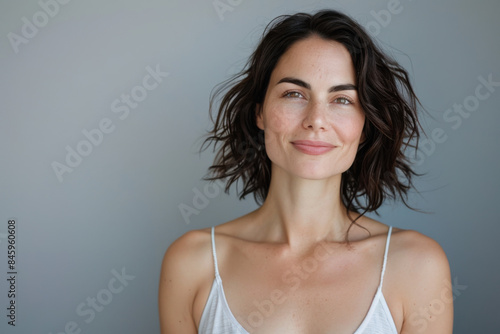 A close up portrait of a woman with a subtle smile