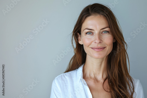 A close up portrait of a woman with a subtle smile