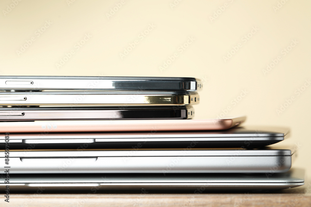Stack of electronic devices on wooden table, closeup Stack of electronic devices on wooden table, closeup