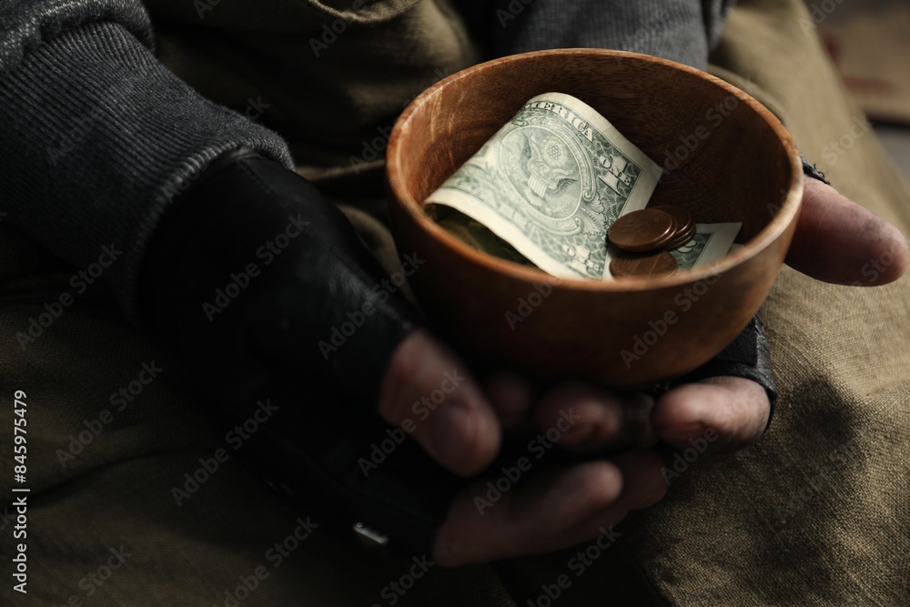 Fototapeta premium Poor homeless man holding bowl with donations, closeup