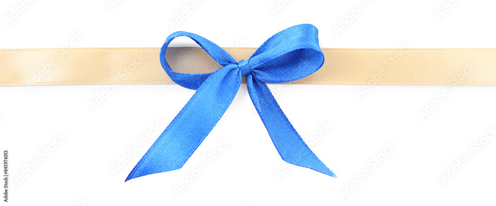 Fototapeta premium Golden satin ribbon with blue bow isolated on white, top view