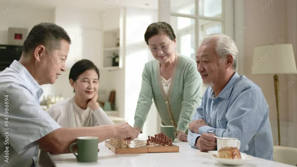 group of four happy senior asian people two old couples gathering at home playing chess group of four happy senior asian people two old couples gathering at home playing chess
