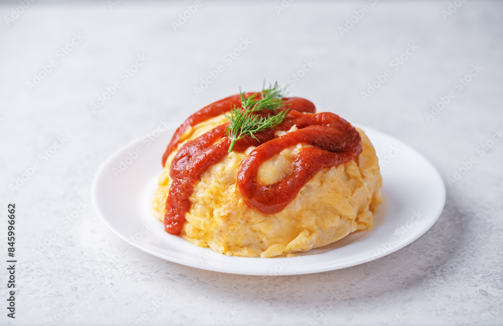 Omurice with ketchup sauce in a plate Omurice with ketchup sauce in a plate