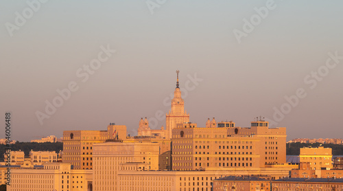 View of the building of Moscow State University (MSU) and the situation center of the Ministry of Defense in the rays of the dawn sun on a summer morning