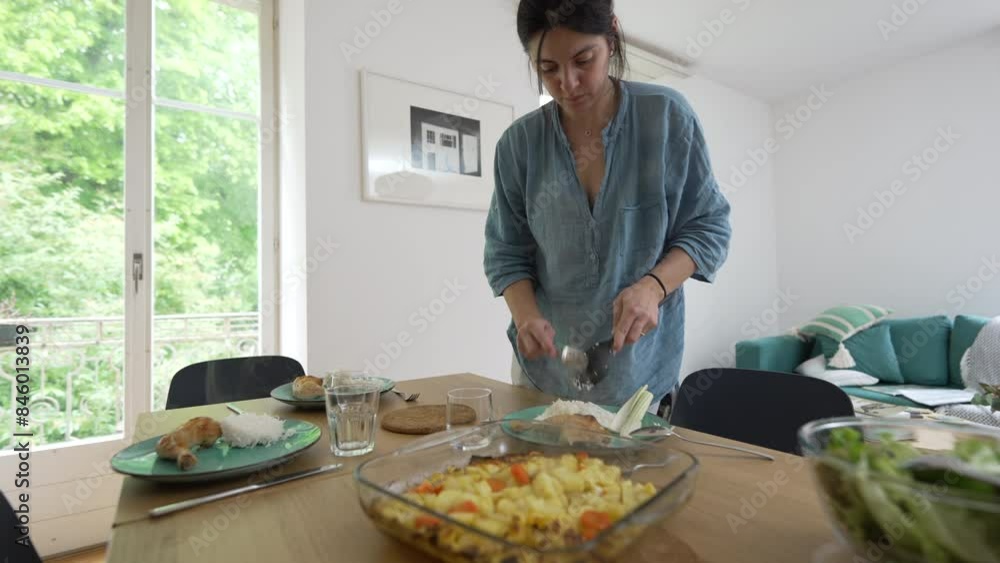 Woman serving a home-cooked meal in a bright living-room. the joy of preparing and sharing meals, emphasizing family togetherness and the comfort of homemade food Woman serving a home-cooked meal in a bright living-room. the joy of preparing and sharing meals, emphasizing family togetherness and the comfort of homemade food