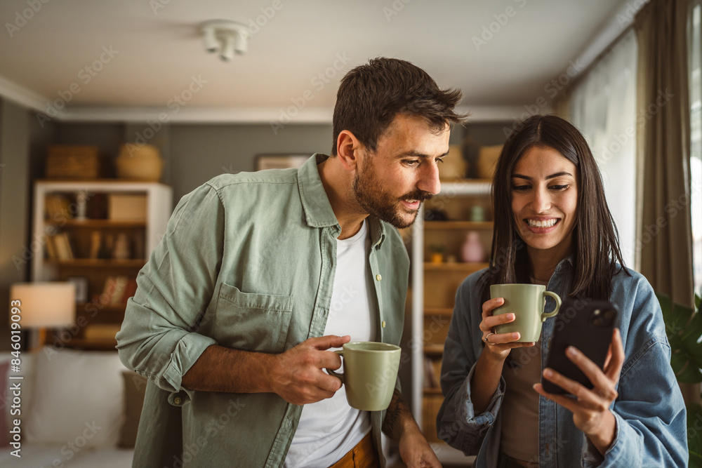 Couple use mobile phone for text message or browse internet at home Couple use mobile phone for text message or browse internet at home