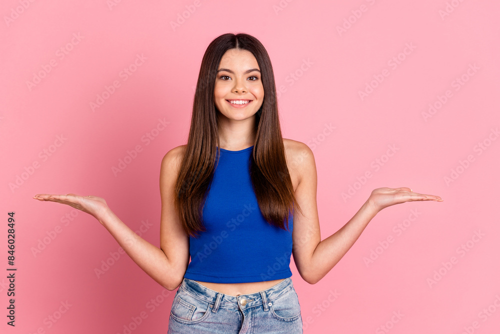 Photo of shiny attractive lady dressed blue singlet comparing arms empty space isolated pink color background Photo of shiny attractive lady dressed blue singlet comparing arms empty space isolated pink color background