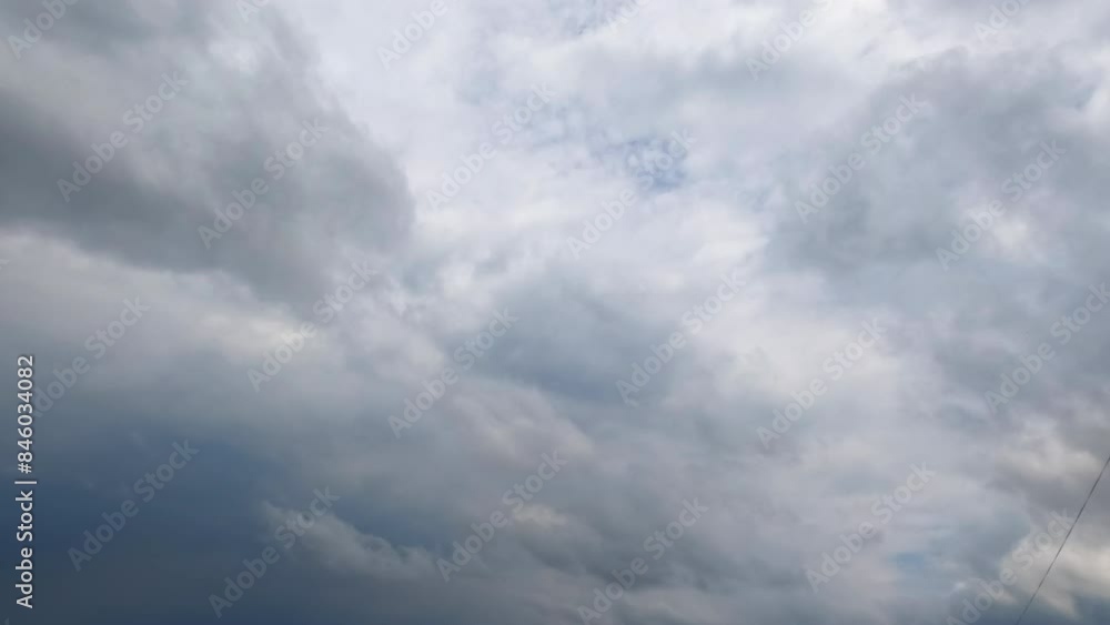 Huge grey clouds gather in atmosphere. Low angle view on the dramatic rainy cloudscape spreading by the sky. Timelapse. Huge grey clouds gather in atmosphere. Low angle view on the dramatic rainy cloudscape spreading by the sky. Timelapse.