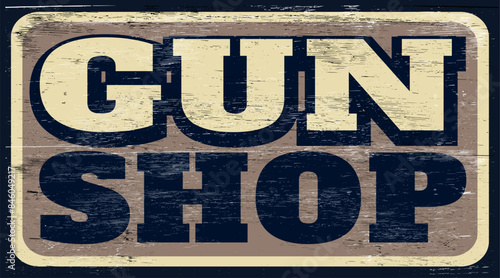 Aged and worn gun shop sign on wood