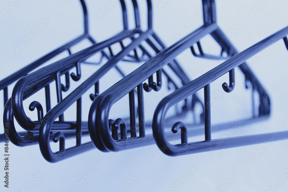 Black hangers hanging on a white background Black hangers hanging on a white background