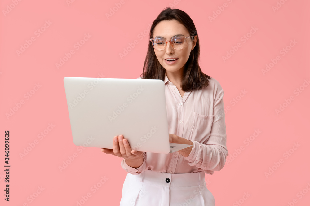 Young businesswoman with laptop on pink background Young businesswoman with laptop on pink background