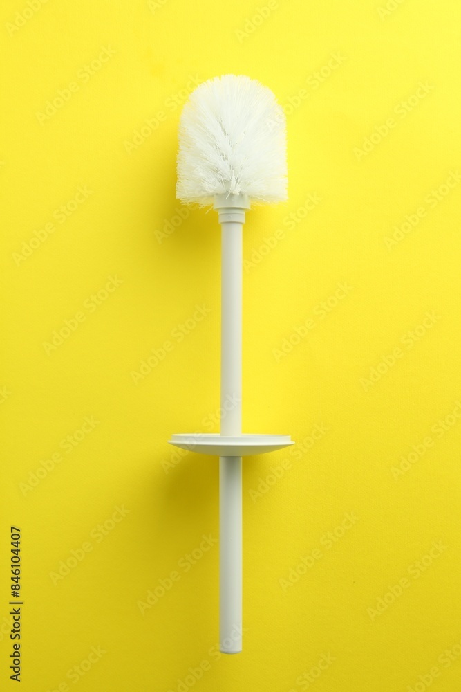 Toilet brush on yellow background, top view Toilet brush on yellow background, top view