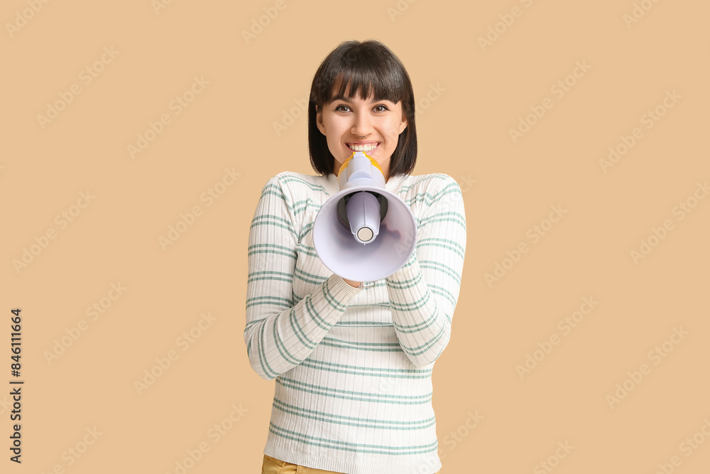 Young woman with megaphone on beige background Young woman with megaphone on beige background
