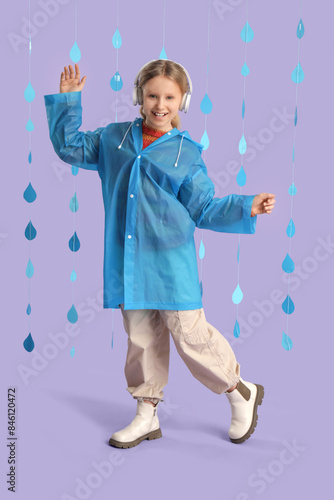 Adorable girl in raincoat w...