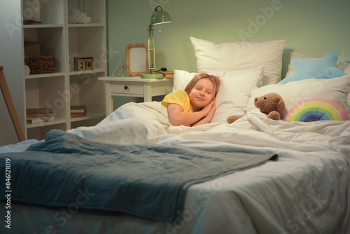 Adorable girl with teddy be...