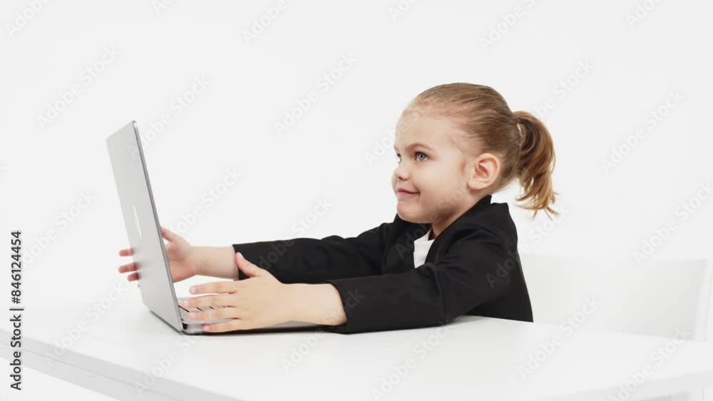 Close-up of a stylish business girl child studying at a laptop on an isolated white background. The concept of modern technology, business and education. Close-up of a stylish business girl child studying at a laptop on an isolated white background. The concept of modern technology, business and education.