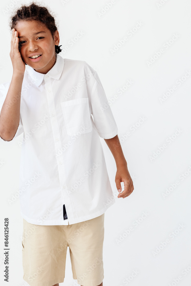 stylish young boy in white shirt and khaki shorts strikes a pose against clean white background stylish young boy in white shirt and khaki shorts strikes a pose against clean white background