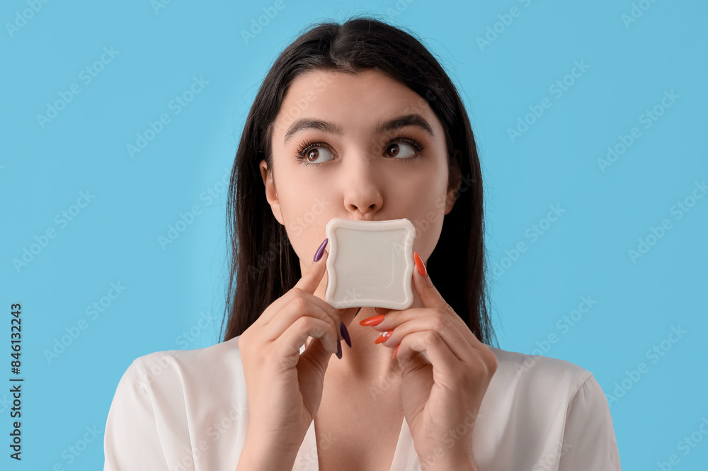 Young woman with soap on blue background, closeup Young woman with soap on blue background, closeup