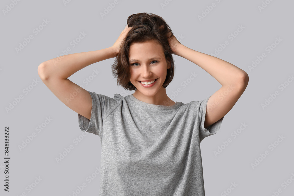 Beautiful young happy woman with bob hairstyle on grey background Beautiful young happy woman with bob hairstyle on grey background