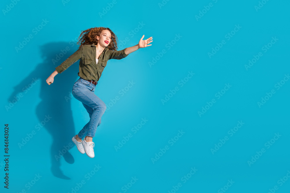 Full body portrait of pretty young woman jump run catch empty space wear shirt isolated on turquoise color background Full body portrait of pretty young woman jump run catch empty space wear shirt isolated on turquoise color background