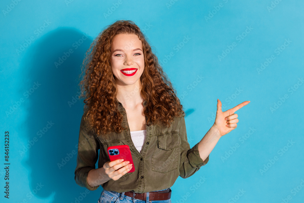 Obraz premium Portrait of pretty young woman phone direct finger empty space wear khaki shirt isolated on turquoise color background