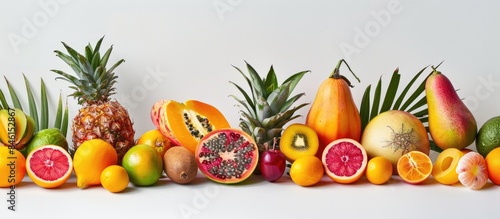 Mixed tropical fruits displayed against a white backdrop