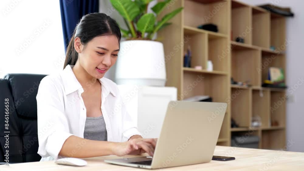 Young asian woman working at home. Female using computer laptop on desk at house Young asian woman working at home. Female using computer laptop on desk at house