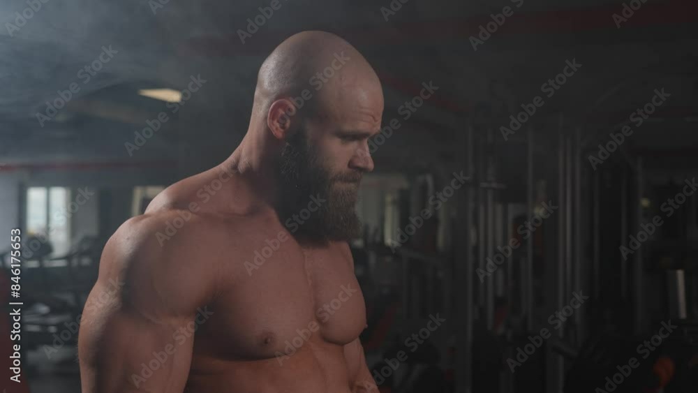 Portrait of a muscular bald shirtless man in the gym. Portrait of a muscular bald shirtless man in the gym.