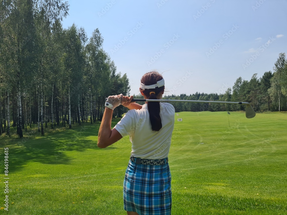 Woman Golfing On A Sunny Summer Day In A Green Field Woman Golfing On A Sunny Summer Day In A Green Field