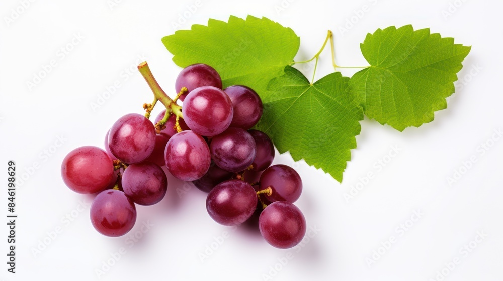 Fototapeta premium Red grapes with green leaves and half sliced on white background. 