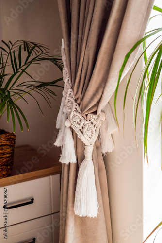 curtain tieback in boho style in interior photo