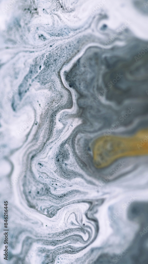 Naklejka premium Ink fluid mix. Marble texture. Defocused white gray color golden sand particles pigment powder acrylic swirl paint emulsion fluid spill abstract art background.
