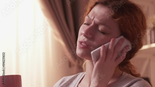 Angry call. Unhappy customer. Displeased frowning woman sigh smartphone fraud arguing nasty conflict scam quarrel finish conversation hold mug coffee.