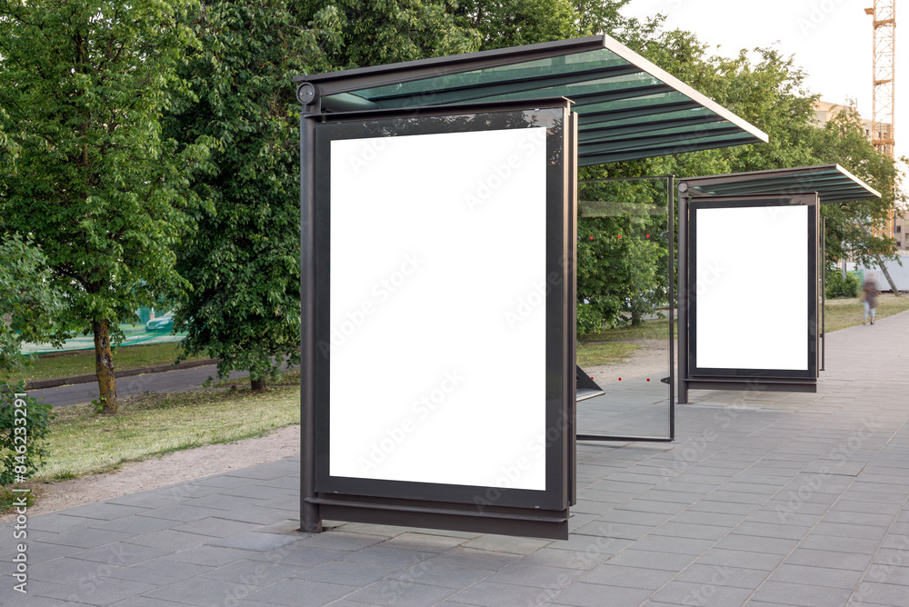 Two Blank Mockups Of Bus Stop Advertising Poster Billboards. White Empty Outdoor Ad Lightboxes On The Sidewalk Two Blank Mockups Of Bus Stop Advertising Poster Billboards. White Empty Outdoor Ad Lightboxes On The Sidewalk