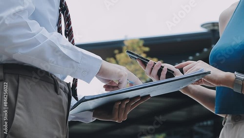 Insurance agent writing on clipboard while examining car after accident claim being assessed and processed photo