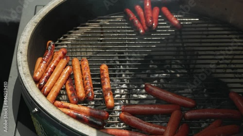 Hot dogs on grill in smoker. photo