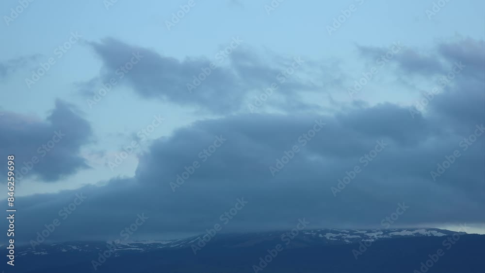 Timelapse of moving clouds in mountains with snow, at dusk. Creative. Covering clouds in snowy rocky mountains. Cumulus clouds below snowy peaks of a Mountain. Vitosha mountain, Bulgaria Timelapse of moving clouds in mountains with snow, at dusk. Creative. Covering clouds in snowy rocky mountains. Cumulus clouds below snowy peaks of a Mountain. Vitosha mountain, Bulgaria