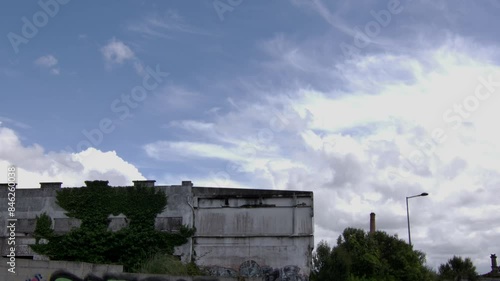 A building corner with some bushes and the sky photo