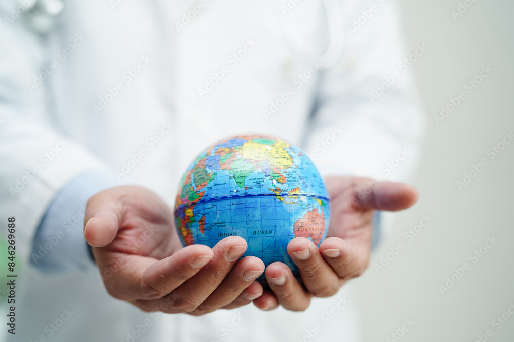 Asian man doctor holding globe, Elements of this image furnished by NASA. Asian man doctor holding globe, Elements of this image furnished by NASA.