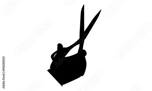 silhouette of hand holding scissor