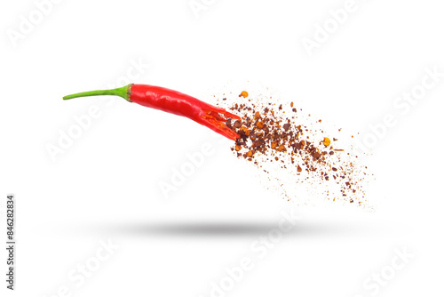 Flying red chili pepper with powder movement isolated on white background. photo