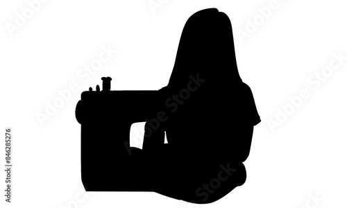 silhouette of woman using sewing machine