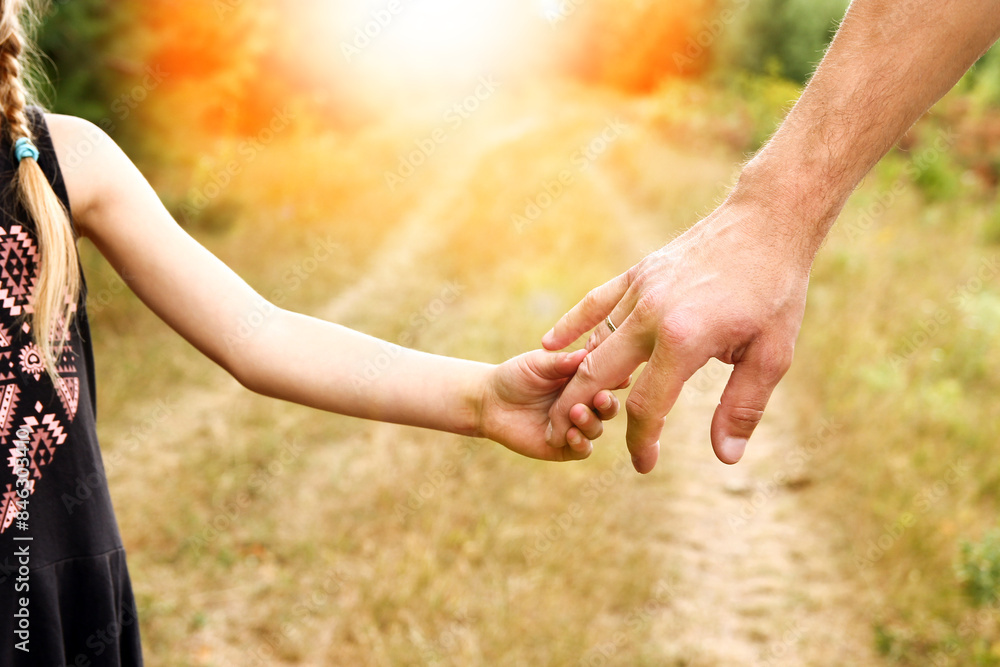 the parent holds the hand of a small child the parent holds the hand of a small child