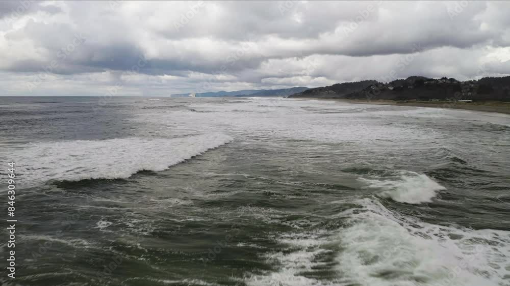 Flying Over Ocean Foamy Waves Along Shore At Neskowin Beach With Cloudy Sky, Oregon Coast, Aerial Low Altitude Flying Over Ocean Foamy Waves Along Shore At Neskowin Beach With Cloudy Sky, Oregon Coast, Aerial Low Altitude