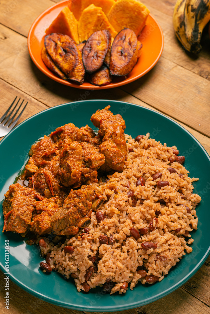 Rice congri with pork fricassee, and fried ripe plantain. Typical Cuban ...
