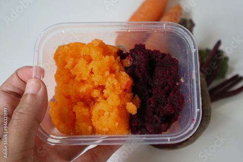 Juice dregs of beetroot and carrots. Can be used for face mask for healthy skin care. squeezed from a slow juicer, zero waste. Fresh beet fruit on the side. photo